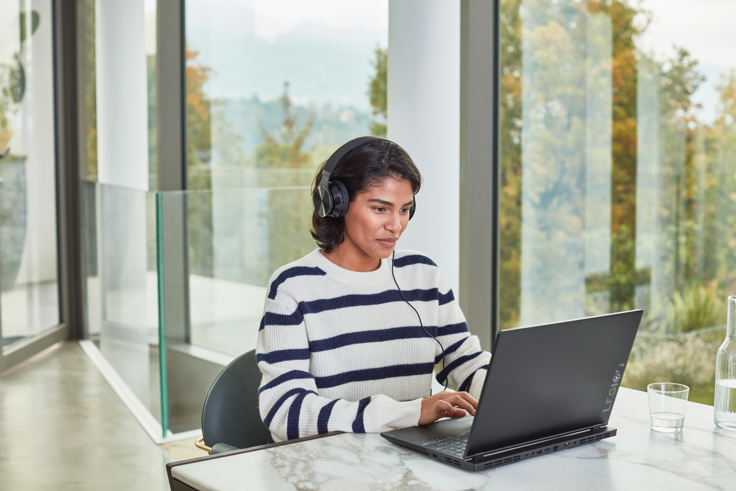 Young adult student inside home gaming. Back to school. Lenovo Legion