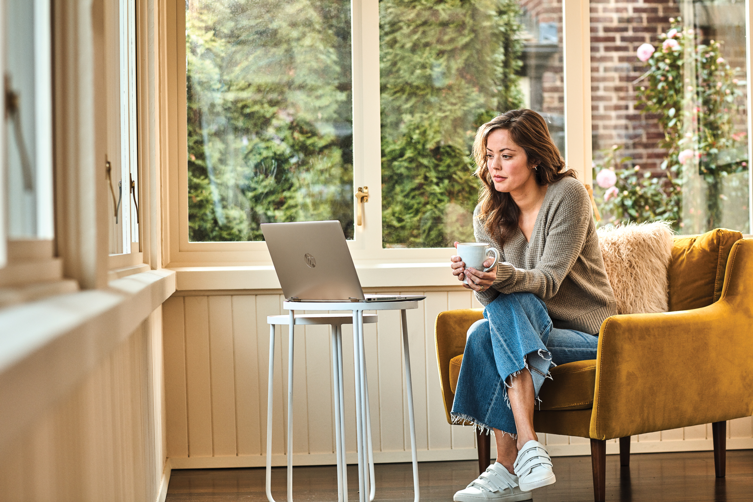 Woman interacting with a HP Pavillion laptop