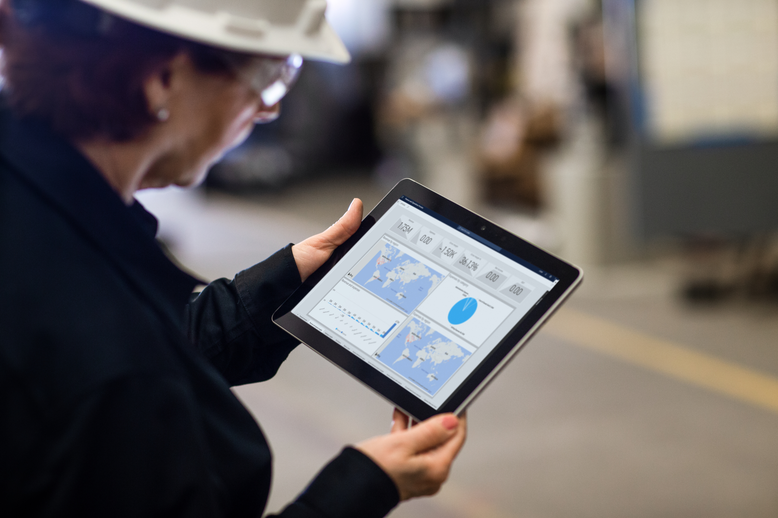Close up of a person holding a tablet with operations dashboard