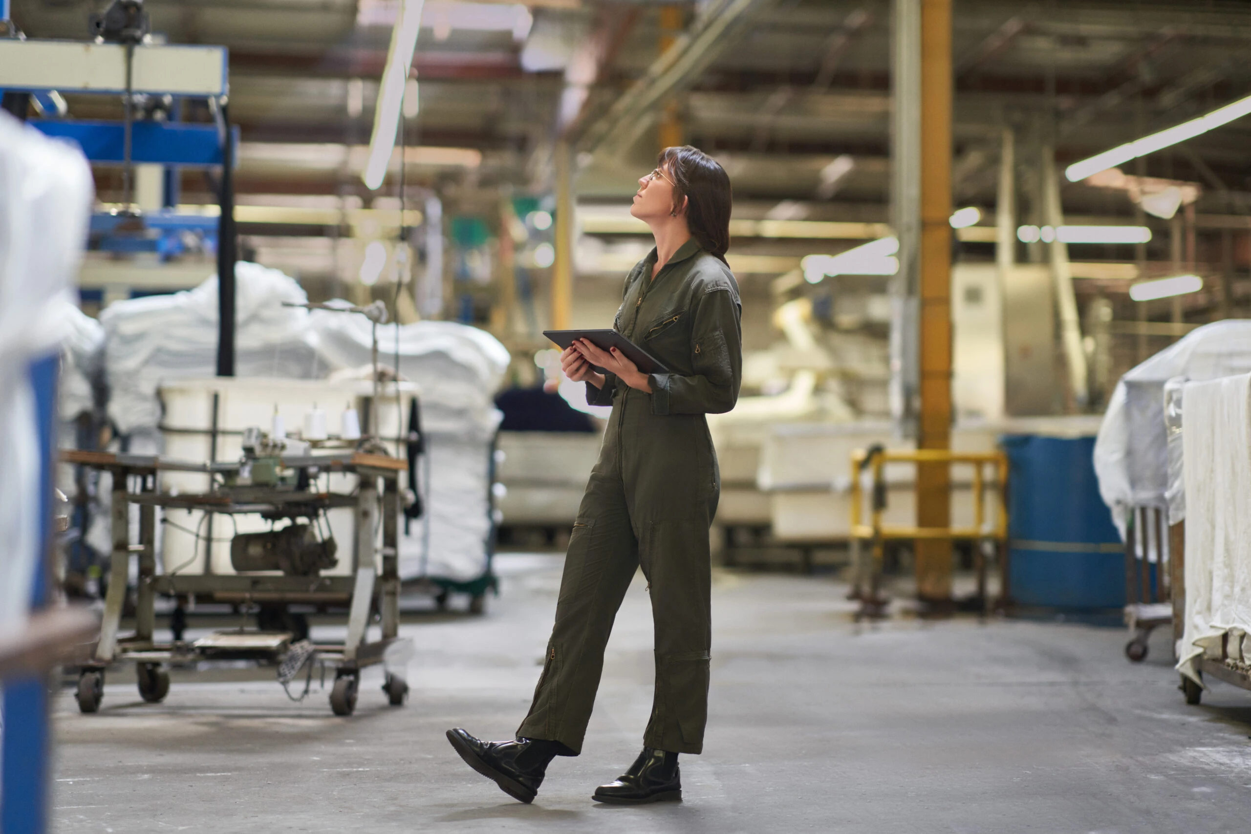 A person standing in a textile warehouse