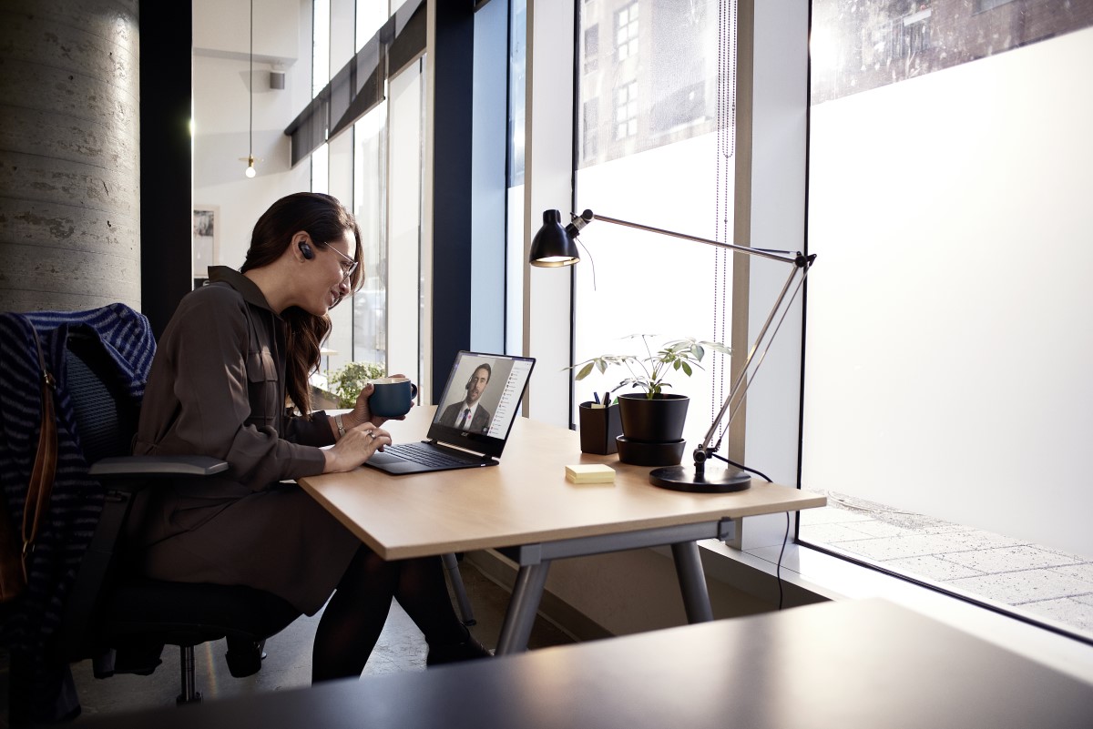 Female small business professional at desk using an Acer Spin 1 device running Microsoft Teams video conference call