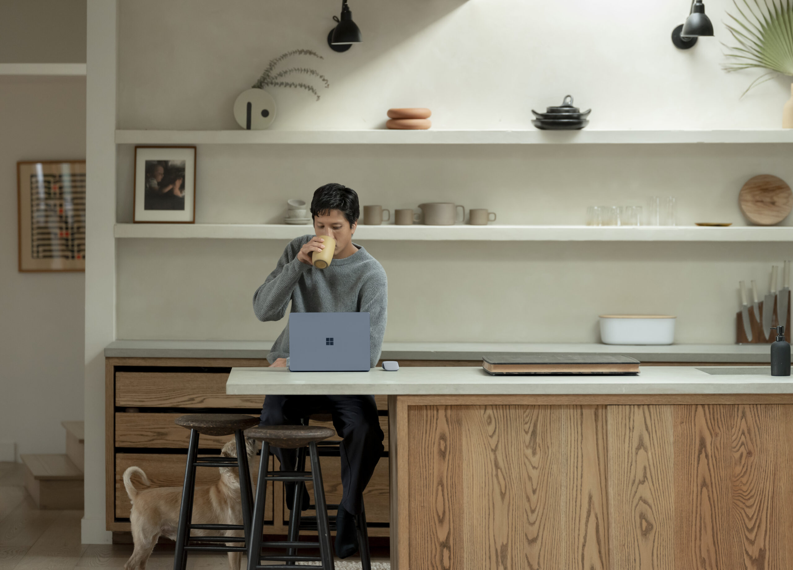 Photo of a man working on a laptop in a kitchen