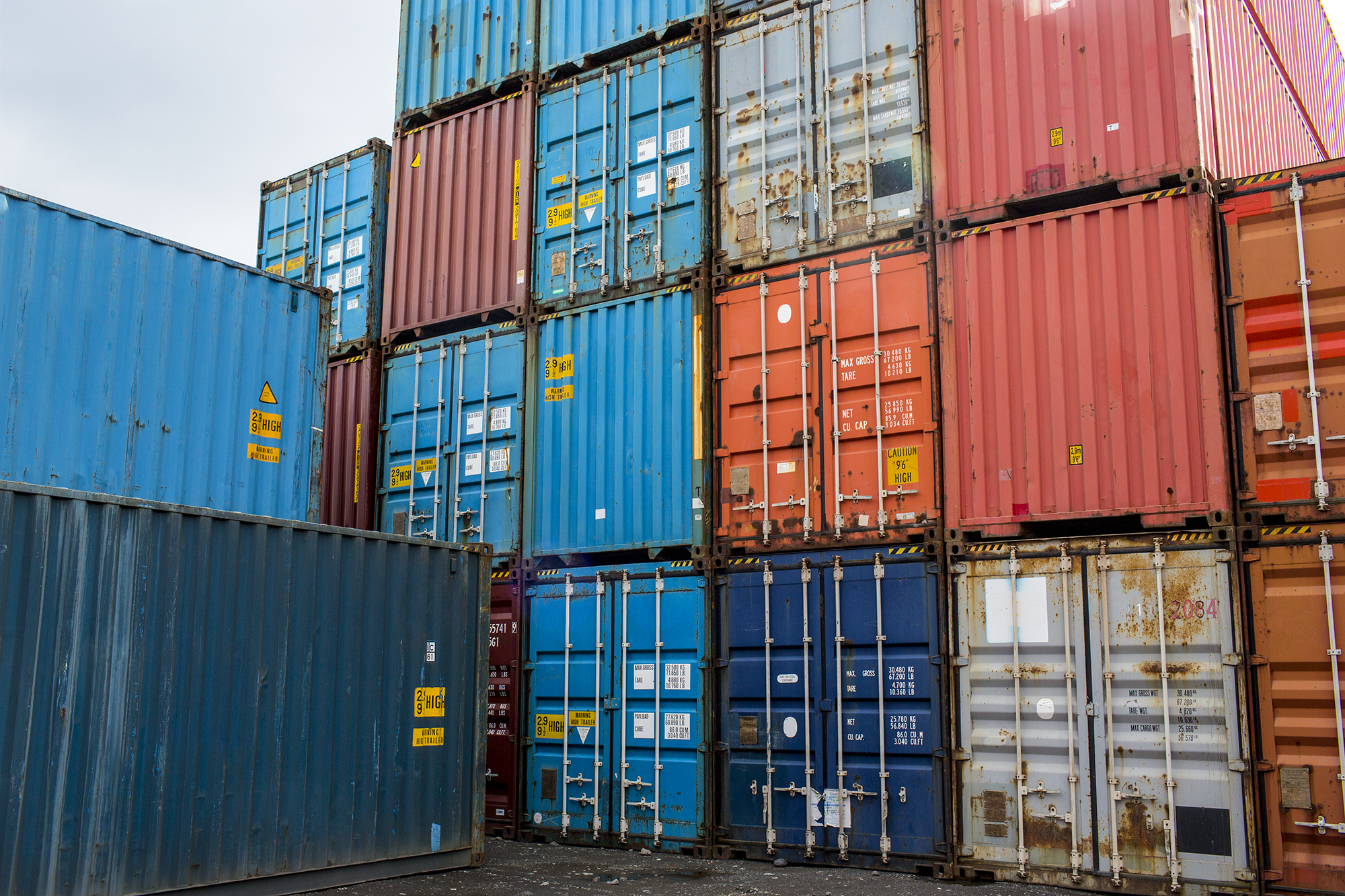 Photo of colorful shipping containers stacked in a shipyard