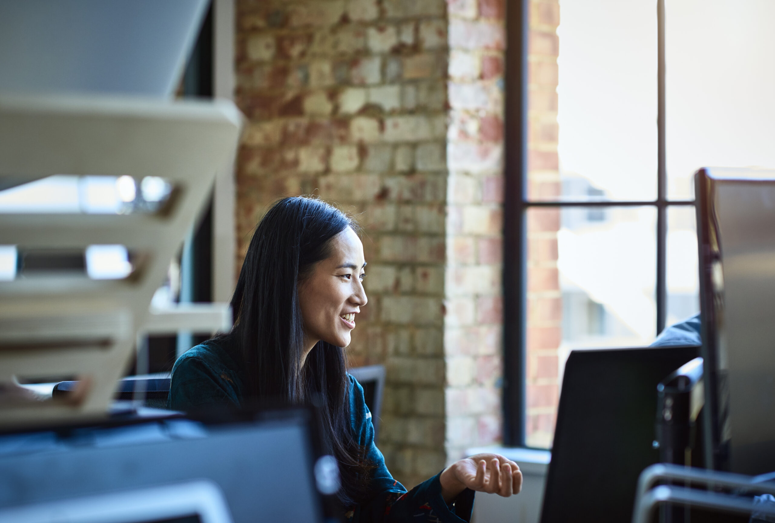 Photo of a Dynamics 365 finance and operations customer sitting at a desk using a laptop computer