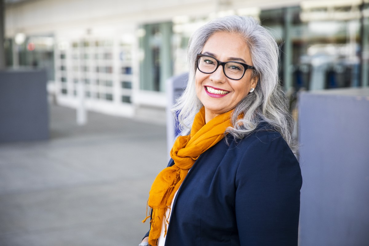 A portrait of a woman standing outside