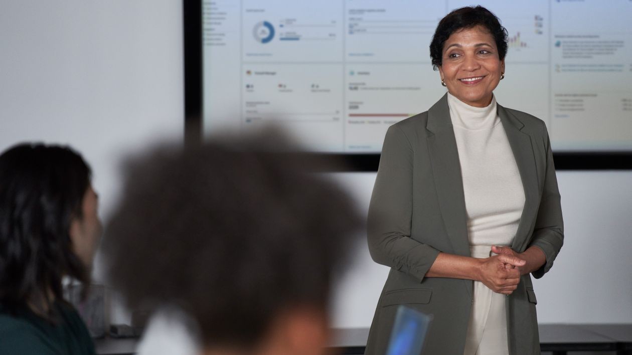 A woman presents information in a meeting