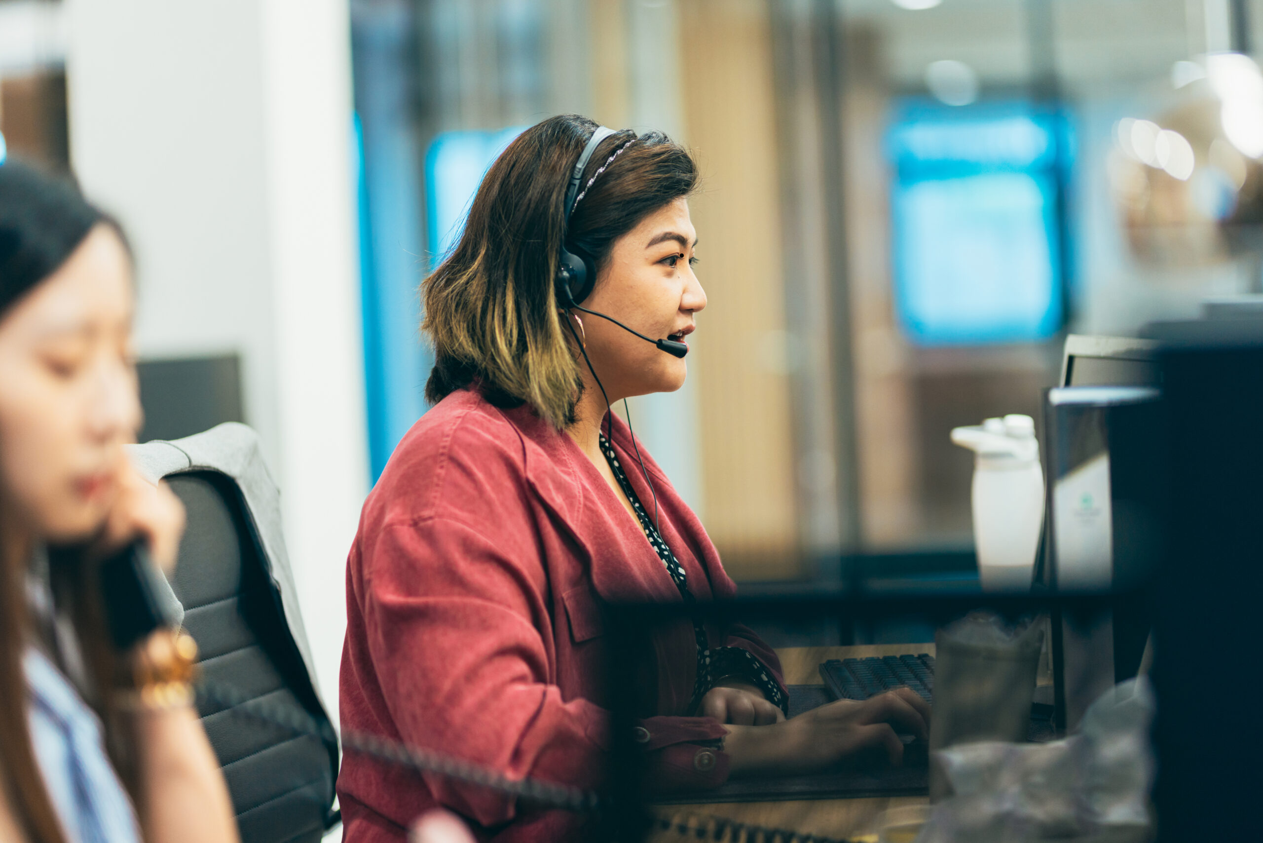 Customer service representative speaking into headset microphone