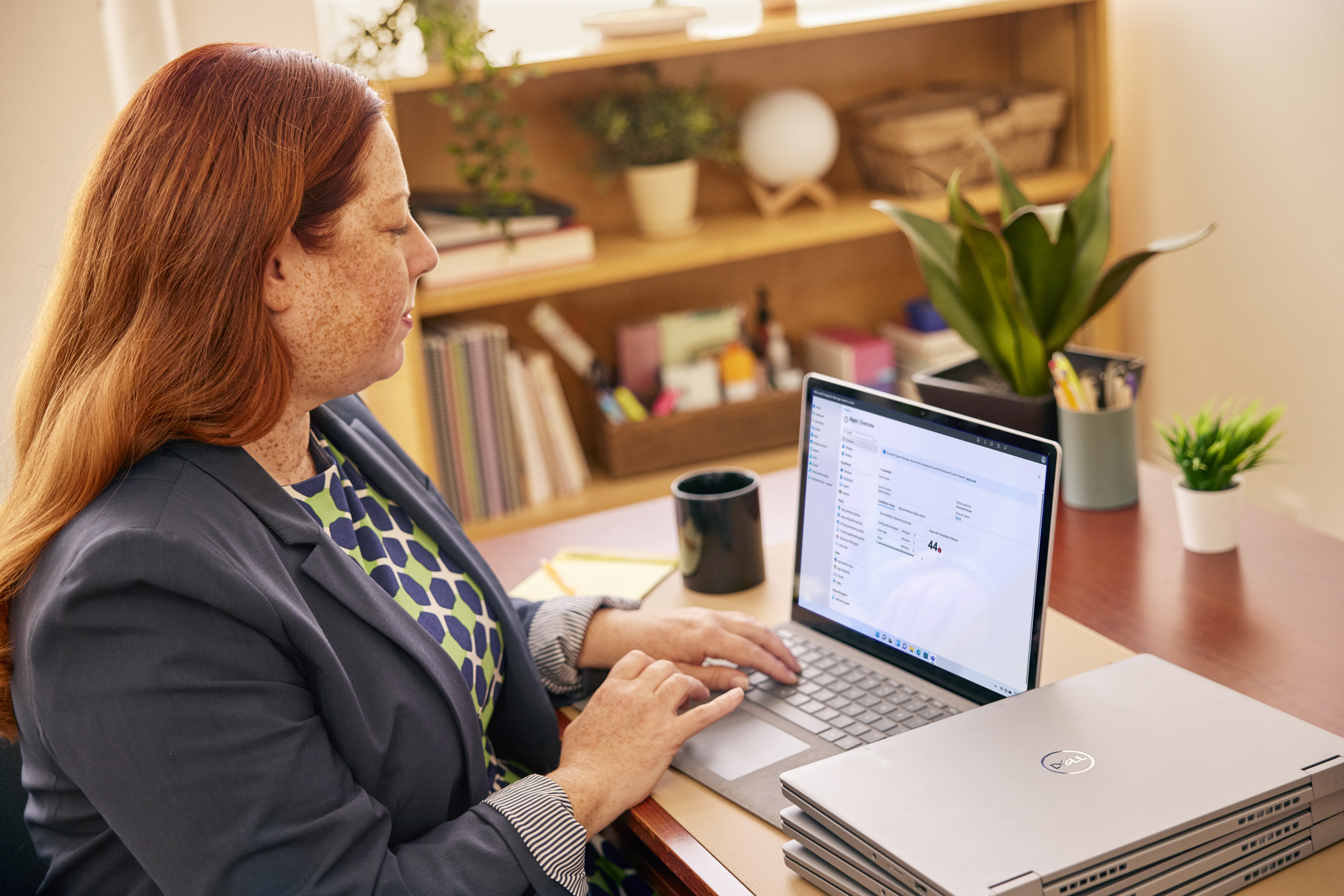 A woman working at her desk on a laptop