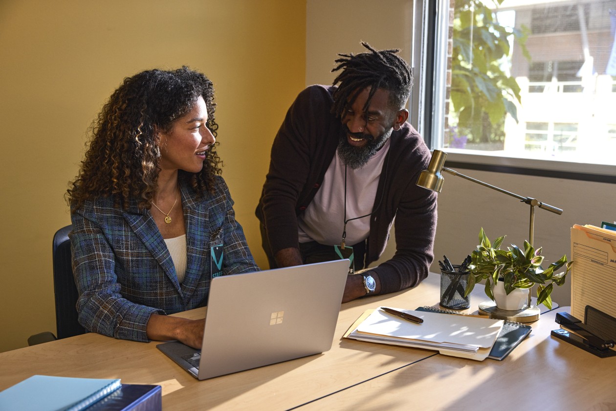 Two education leaders collaborating in an office at a higher education institution