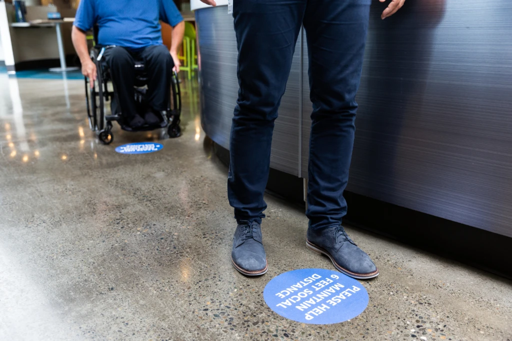 People lining up with social distancing in place. In the new normal, Sainsbury's had to innovate their in-store experiences.
