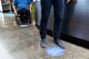 People lining up with social distancing in place. In the new normal, Sainsbury's had to innovate their in-store experiences.