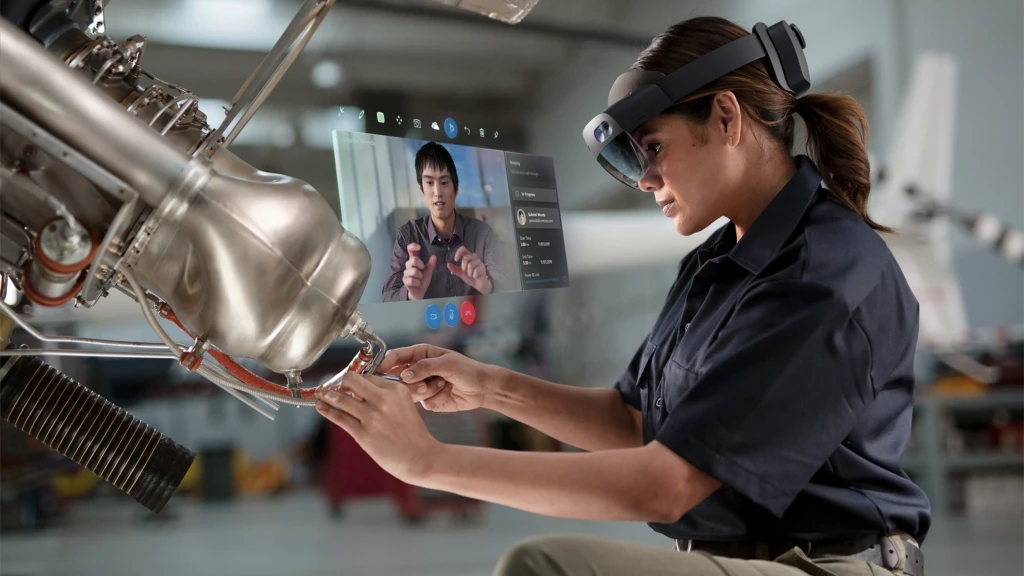 An employee using Microsoft HoloLens to get remote assistance on a machine.