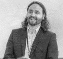 Ben, a person wearing a suit and tie