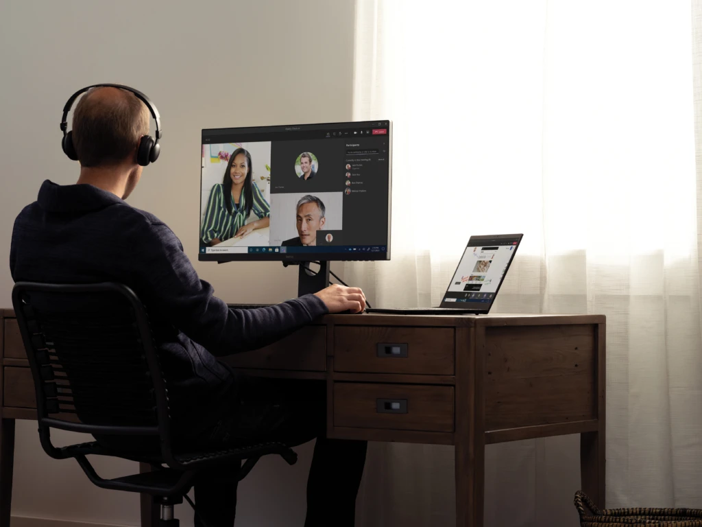 A man working remotely from home. He is in a skills online meeting.