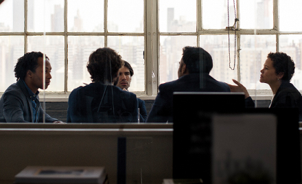 Five people participate in a meeting