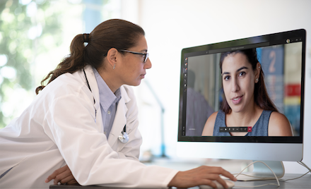 A doctor using Microsoft Teams to have a virtual appointment with a patient