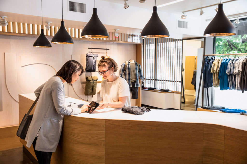 A woman checking out at a clothing store