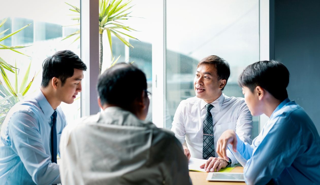 Group of professionals discussing strategic plans in a meeting room