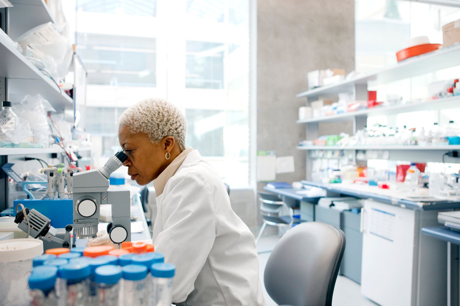 A pharmacist looking in a microscope
