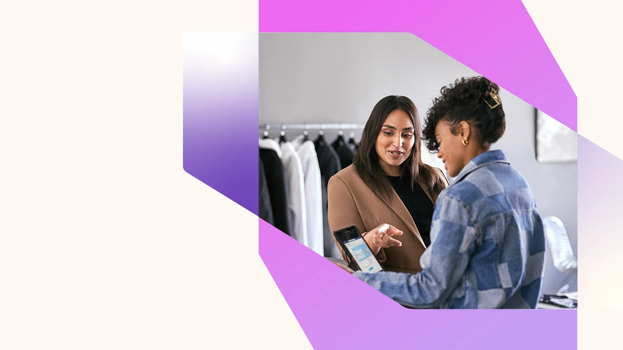 Azure solution powering retail business. Retail business operations manager reviewing real time data with employee