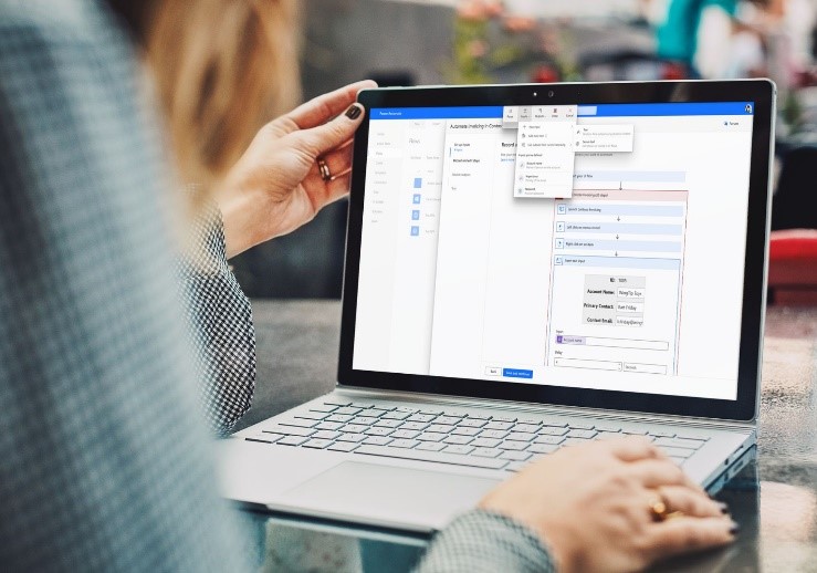 Person working on a laptop with Microsoft Power Automate