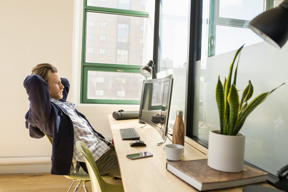 Young, small business male with All-in-one in modern workplace