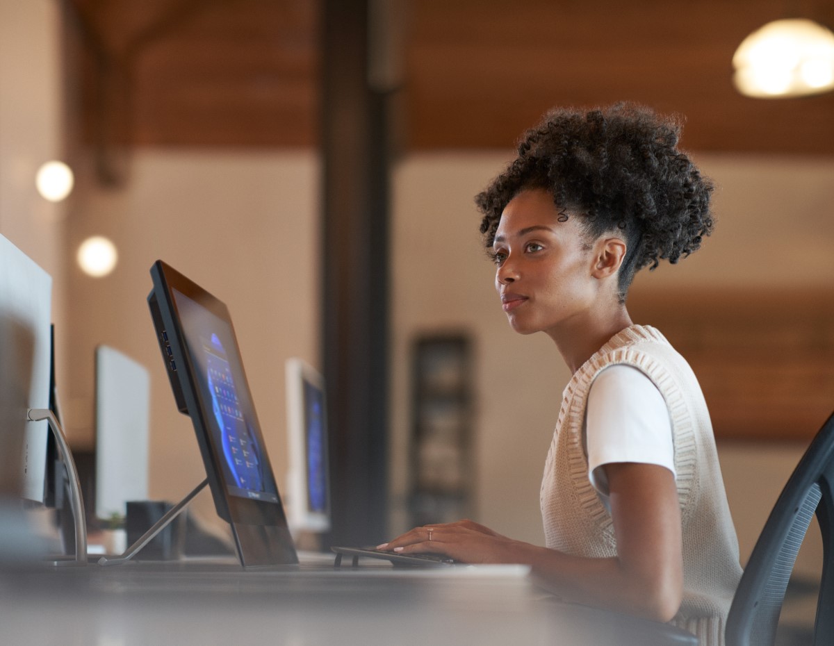 Person sitting at computer in a workspace