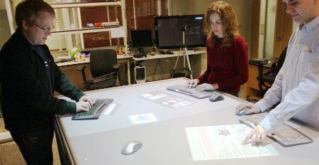 a man standing in front of a computer