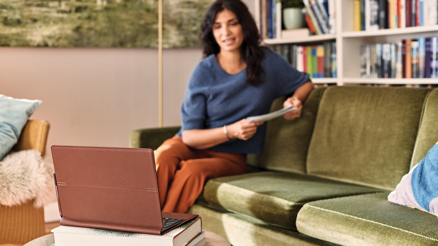 a woman sitting at a table using a laptop