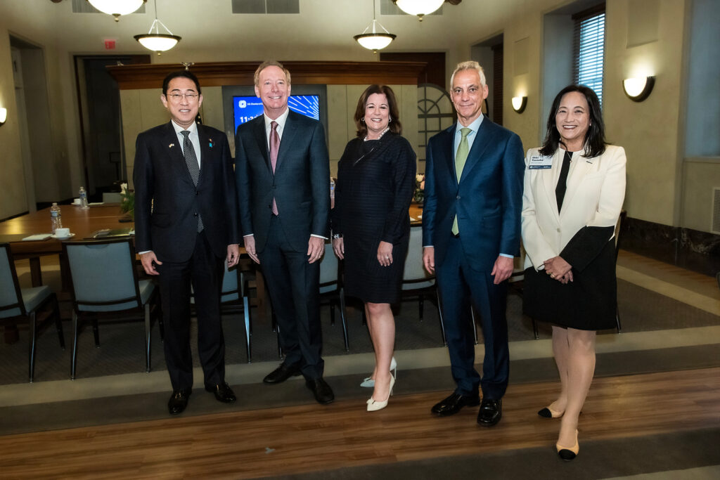 a man standing in front of Fumio Kishida, Brad Smith, Rahm Emanuel, Miki Tsusaka posing for the camera