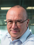 Christopher Bishop wearing glasses and smiling at the camera