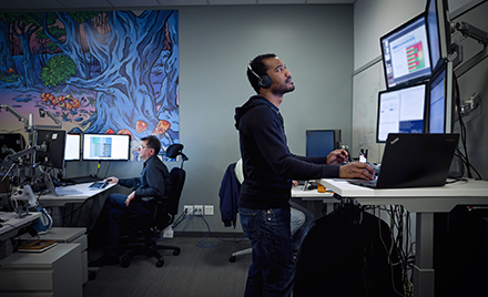 Image of a tech worker looking at a computer monitor
