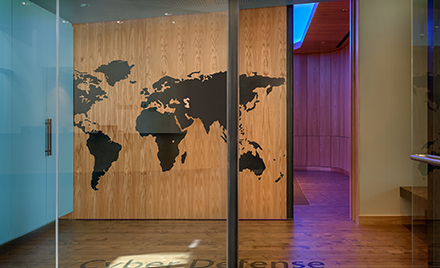 Image of an office hallway with a map of the world carved into it