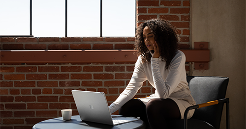 An image of adult female working on Surface Book 3