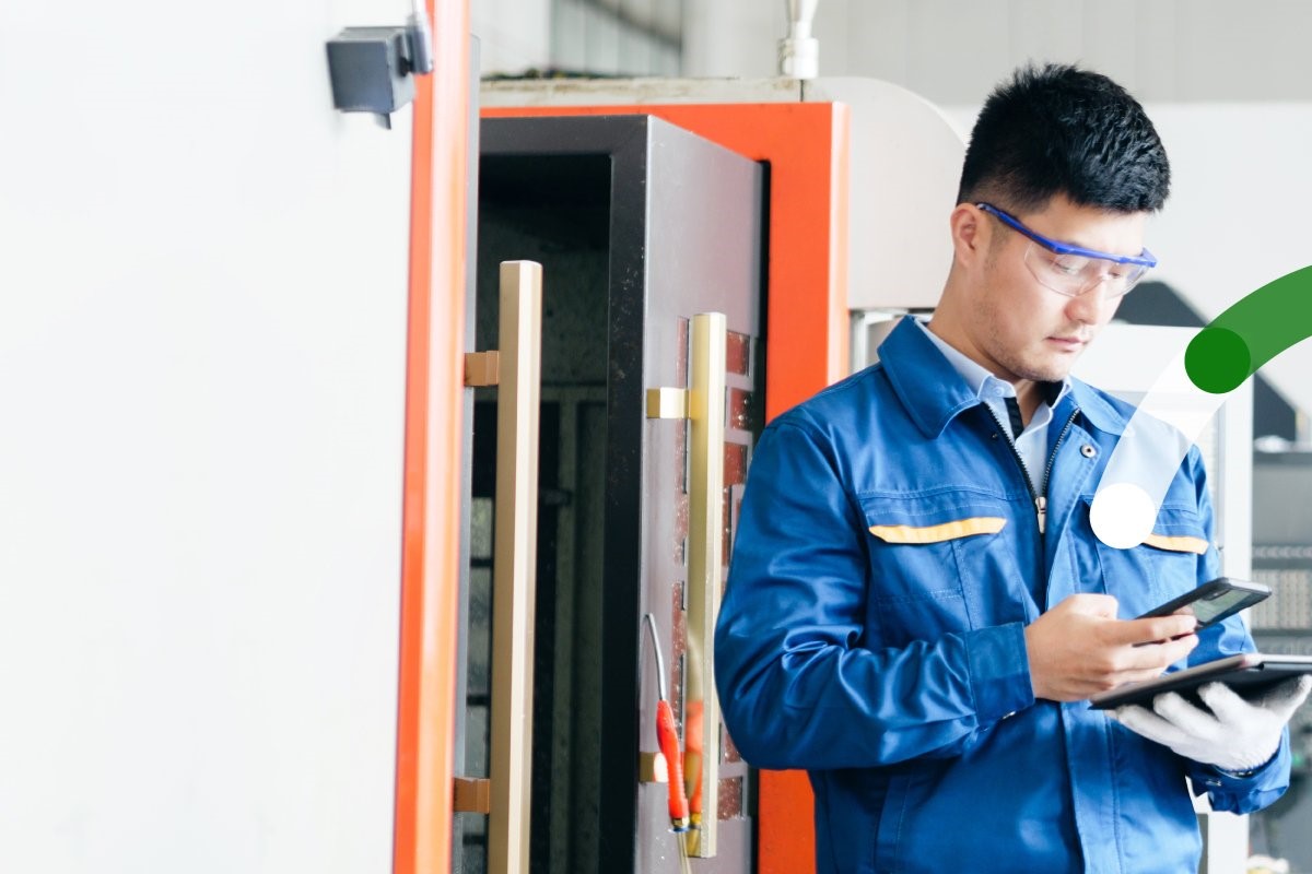 Industry worker utilizing mobile tablet to complete task
