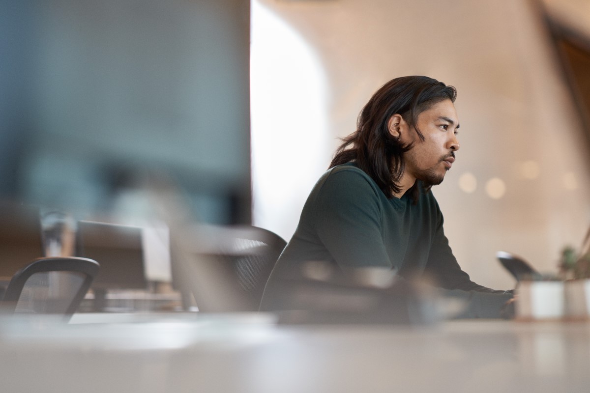 Enterprise office worker in focused work with a neutral facial expression