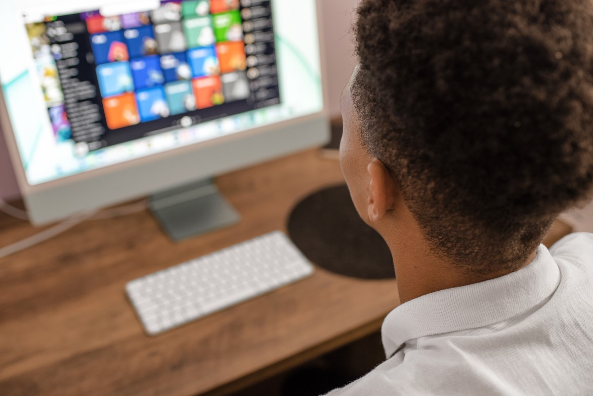 Teenager using desktop computer