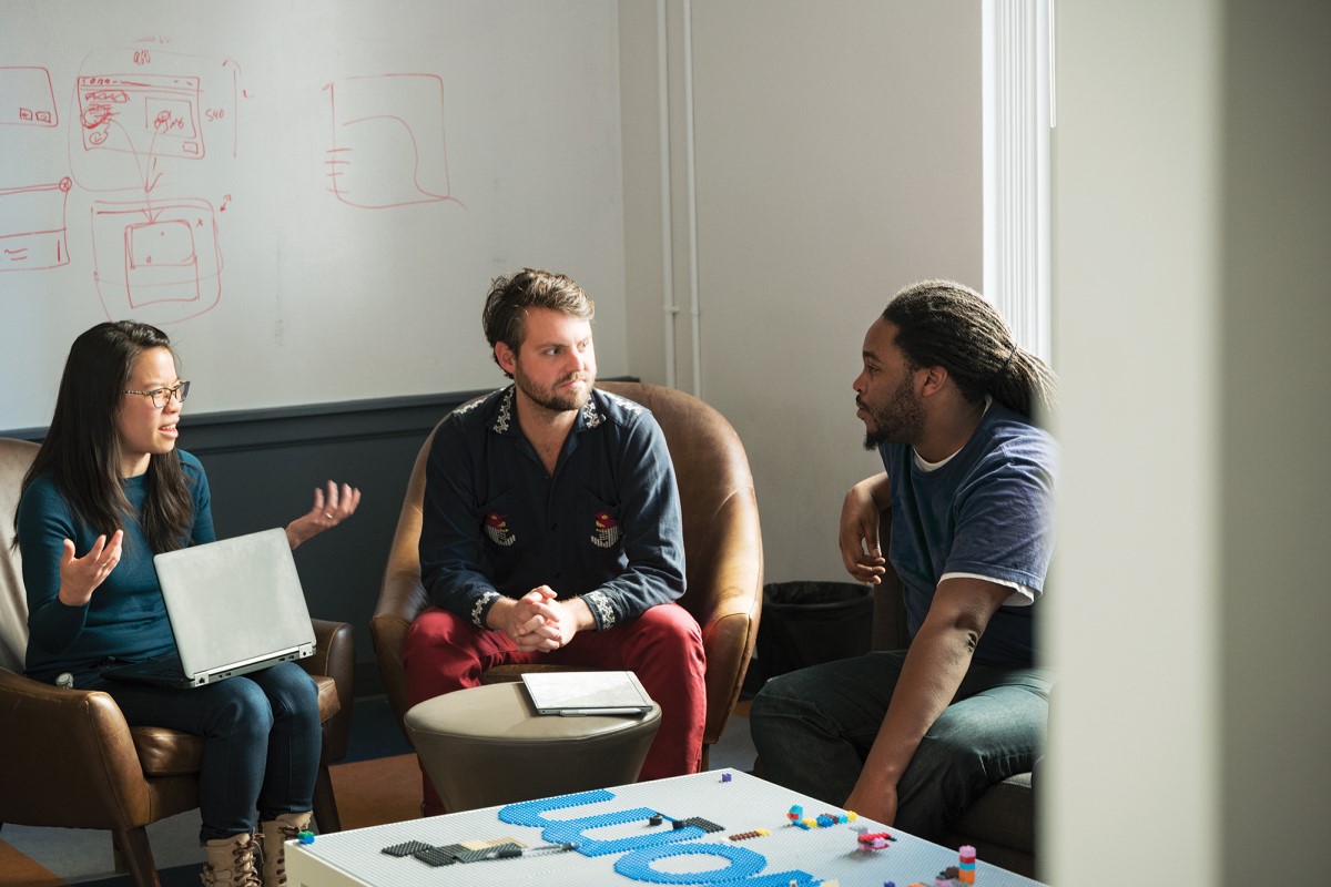 Real people. Customer support/admin meeting at a digital consulting firm. The firm provides custom solutions across a multitude of disciplines including IT, front and back end software development, customer support and data services