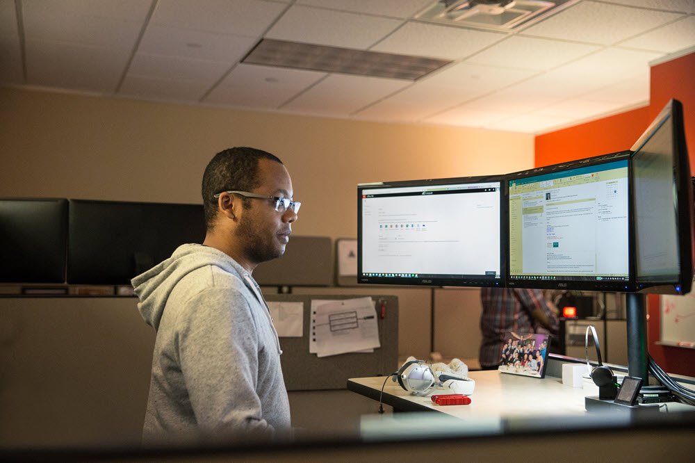 a man standing in front of a computer