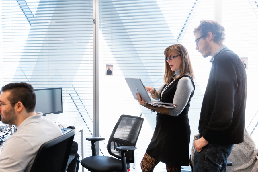 Coworkers standing in open office space