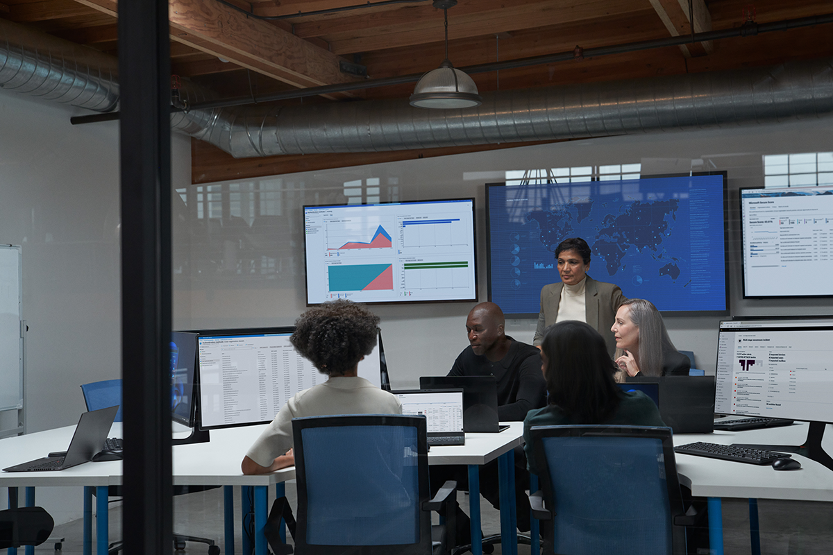 Photo of ISO (chief information security officer) collaborating with practitioners in a security operations center