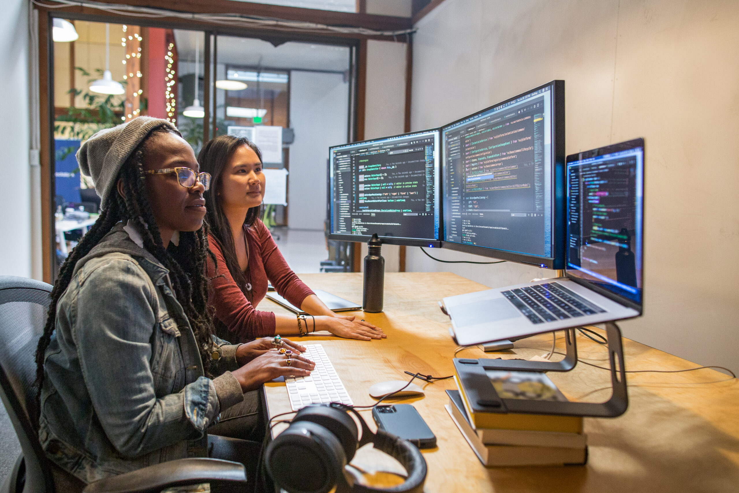 Two female developers working and collaborating in an enterprise office