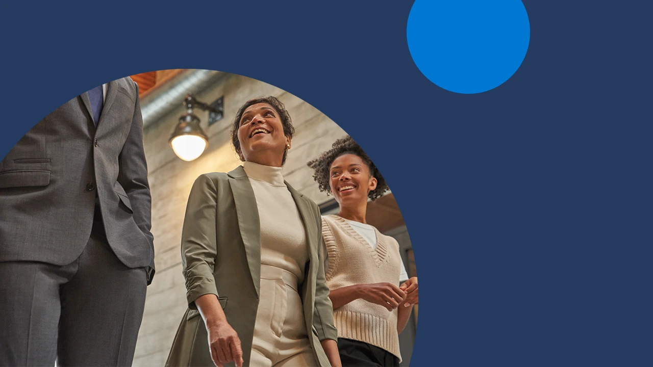 Three business decision makers walking down a hallway