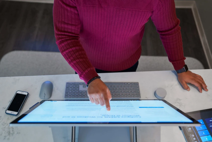 A security practitioner points at a computer screen