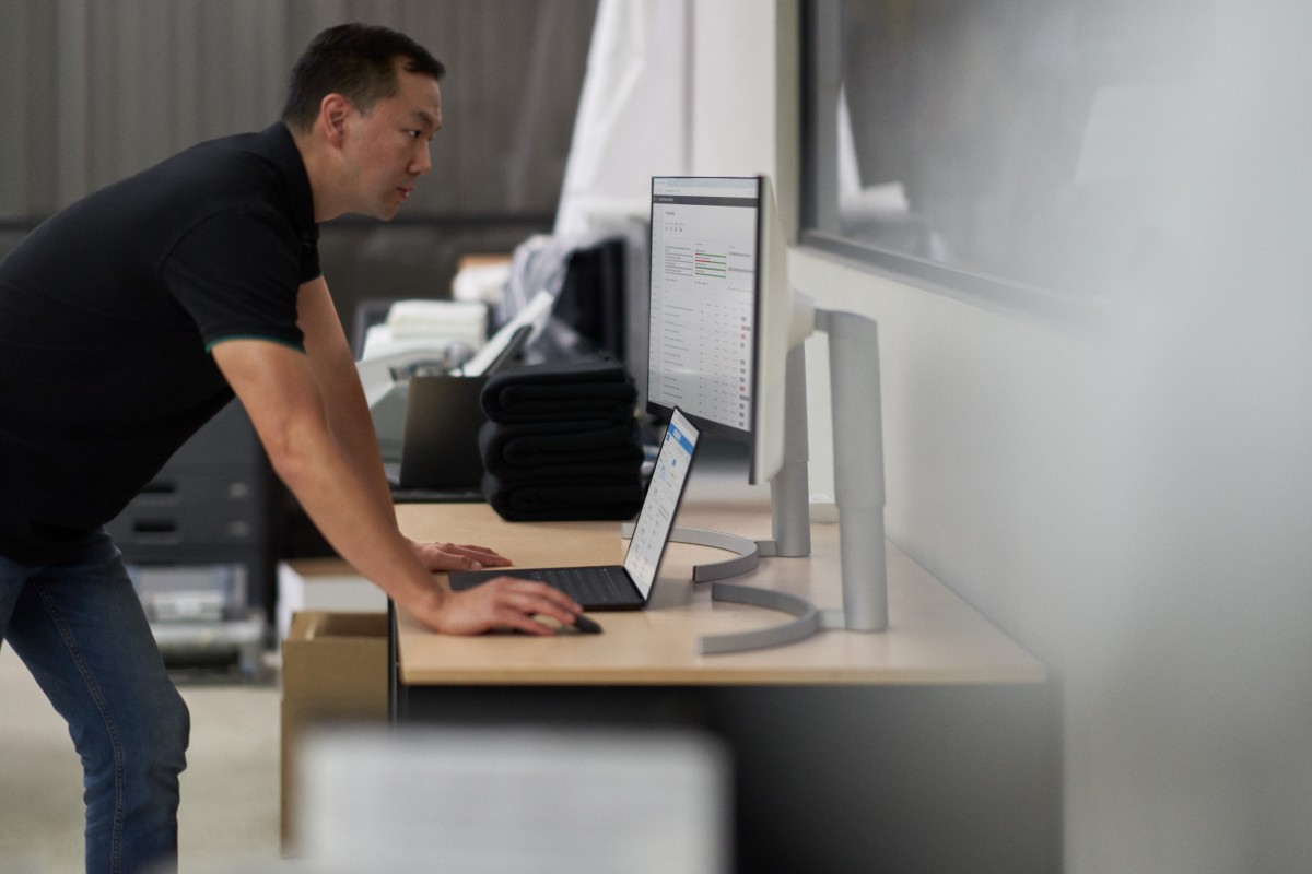 Security practitioner looking at desktop screens and working to investigate threats