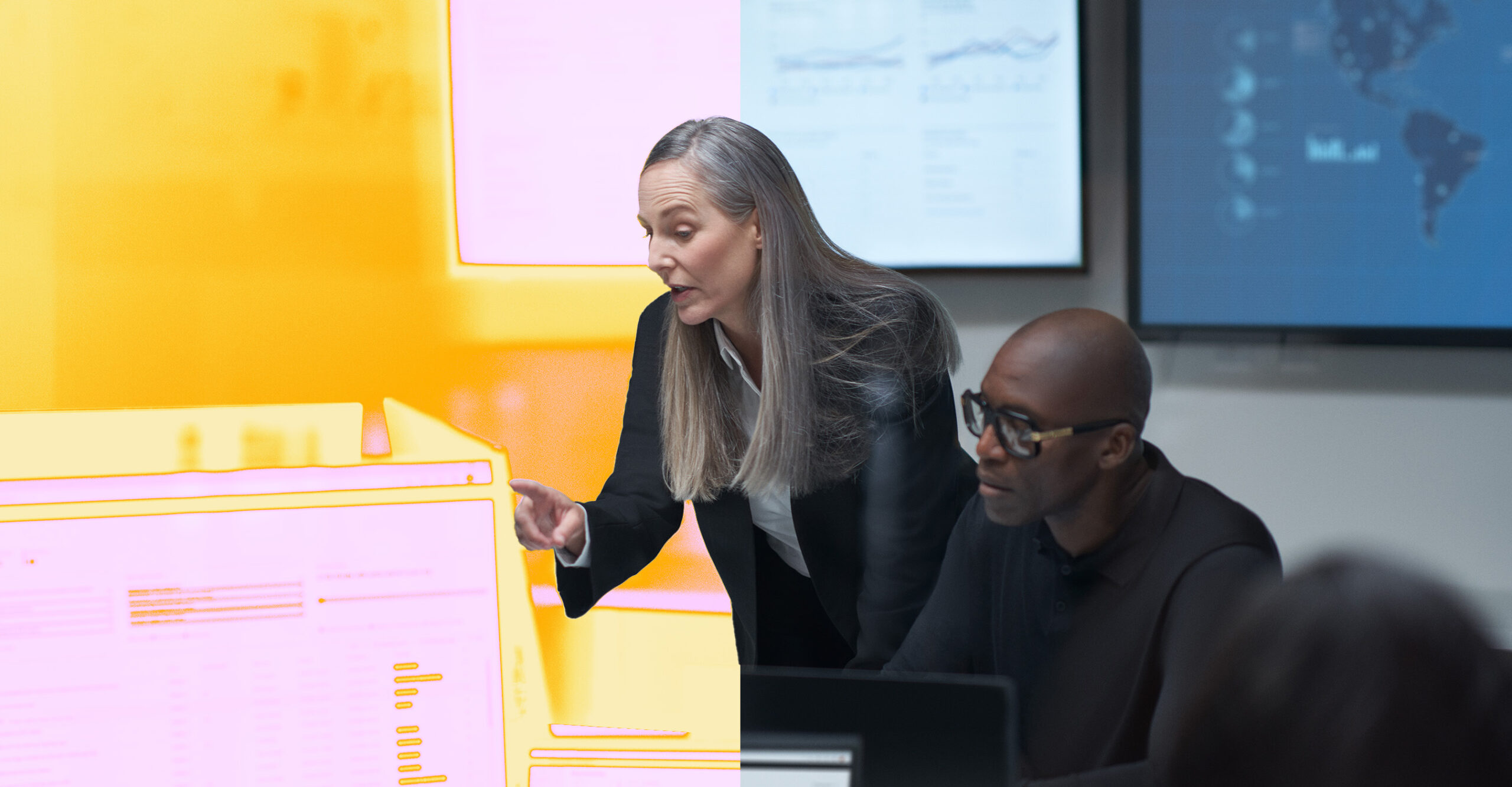 A woman pointing at a computer screen