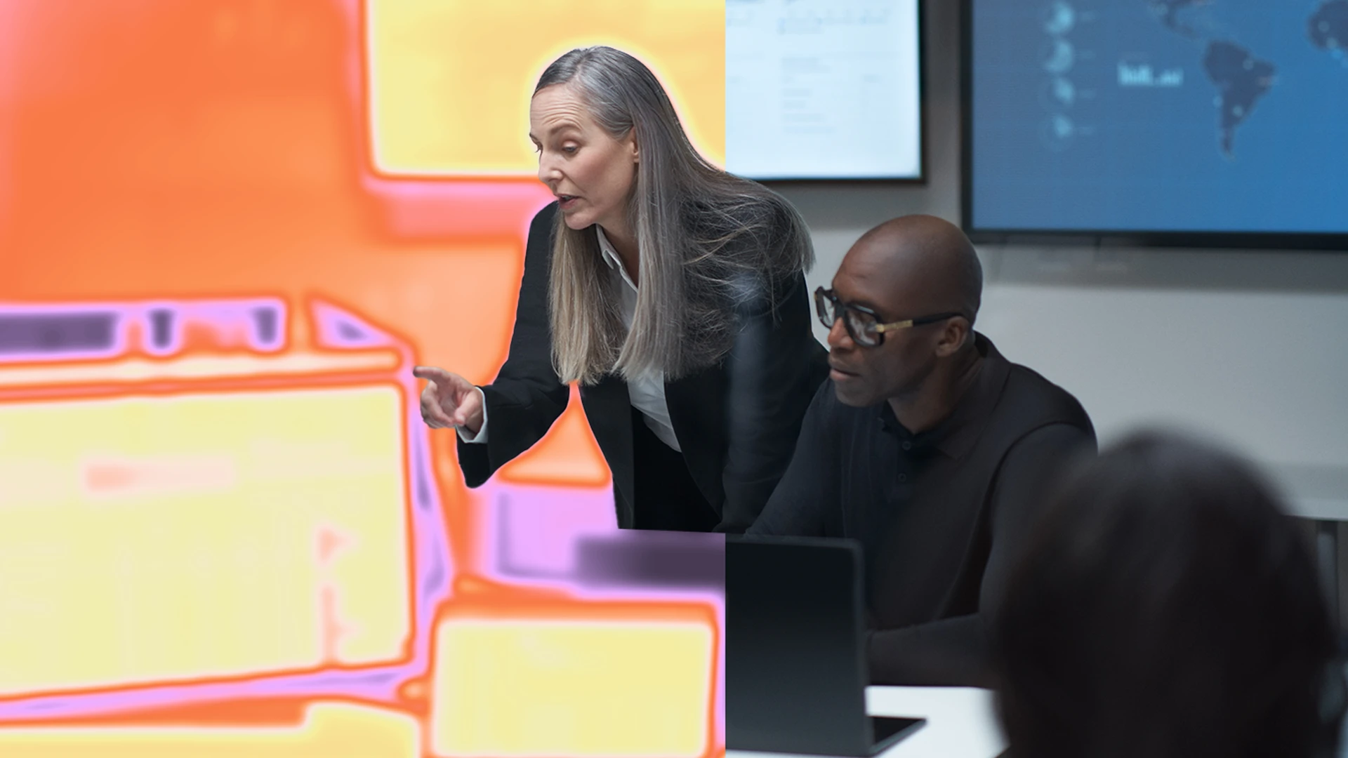 A woman pointing at a computer
