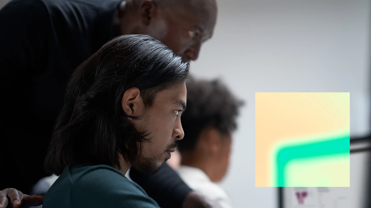 A group of men looking at a computer screen