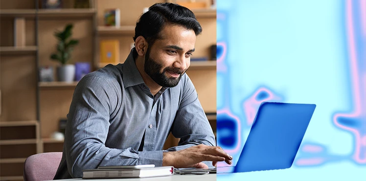 A man sits at a laptop computer. The right side of the image is shaded in blue to symbolize security.