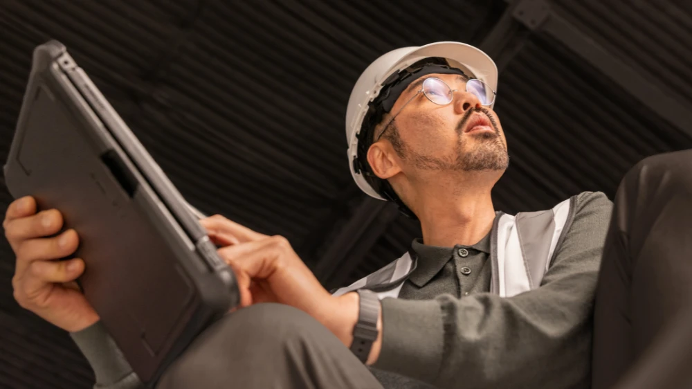 Electric car engineer in focused work on factory floor